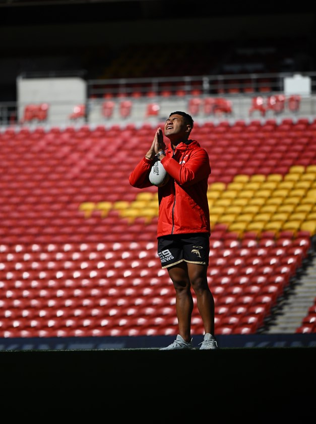 Isaiya Katoa says a prayer before the Dolphins v Titans game.