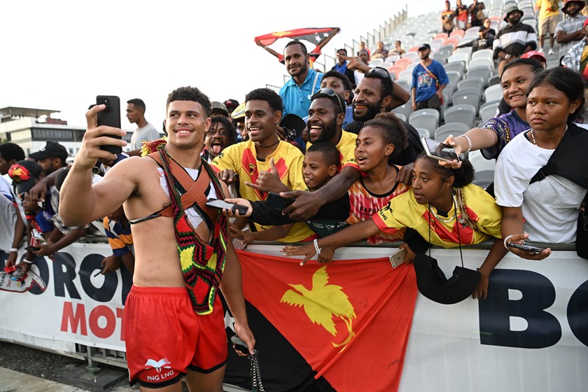 Cooper Bai takes photos with some PNG fans.