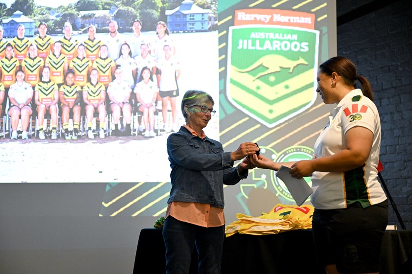 Cathy Welch is presented with her Jillaroos playing pin from current coach Jess Skinner.