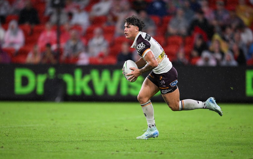 Reece Walsh runs the ball.