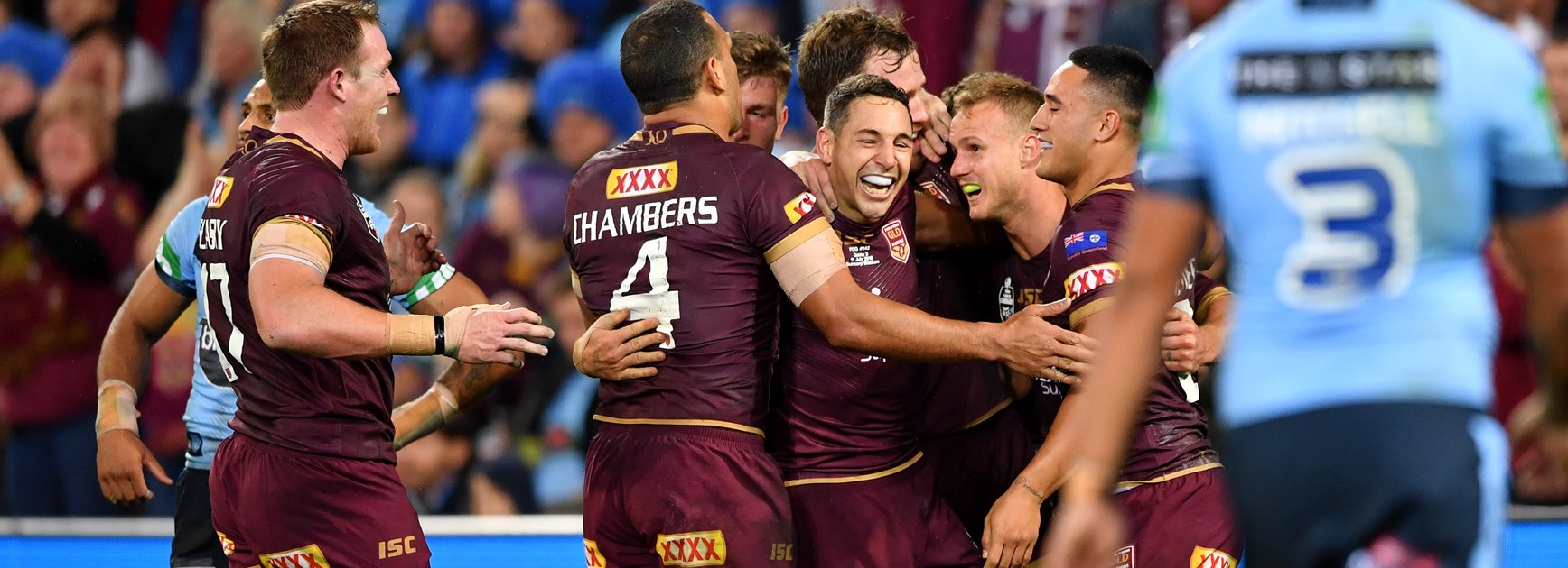 Queensland celebrate a try against NSW.