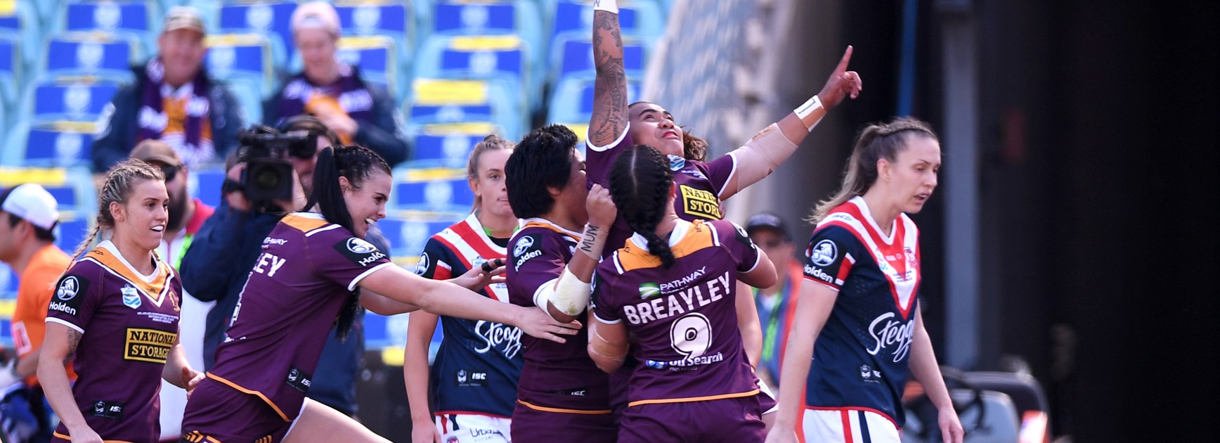 The Broncos celebrate Ngatokotoru Arakua's try.
