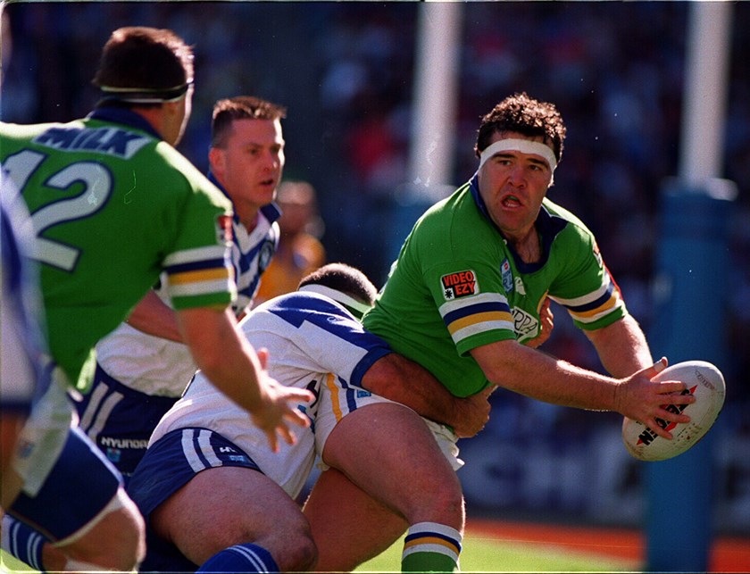 Canberra's unlikely hero Paul Osborne slips a pass for David Furner to score.