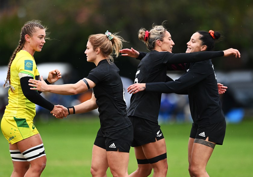 Lily Dick shakes hands with Warriors star recruit Michaela Brake (nee Blyde) after a 2021 trans-Tasman sevens match.